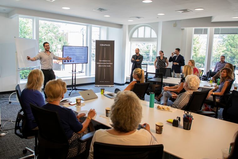 Compass is a fast-growing national real estate brokerage, with multiple offices in the Philadelphia region. In the company's Ardmore office, Joe Aquino, 28 (far left) teaches a group of employees. Aquino is a senior product expert for Compass and is in charge of training and product adoption in the Greater Philadelphia area.