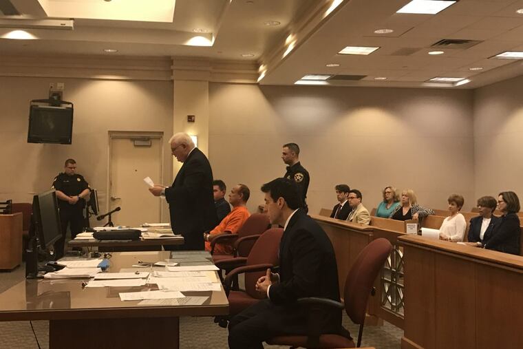 Dr. James Kauffman (in orange), the husband of slain Shore personality April Kauffman, appears in court June 14. Second from right is his wife, Carole Weintraub.