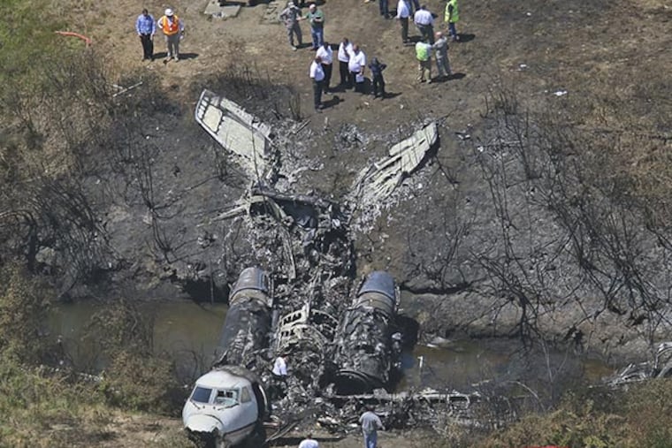 This aerial photo shows the wreckage scene Monday after a plane plunged down and erupted in flames during a takeoff attempt at Hanscom Field on Saturday night in Bedford, Mass. Lewis Katz, co-owner of The Philadelphia Inquirer, and six other people died in the crash. (AP Photo/The Boston Globe, David L. Ryan)