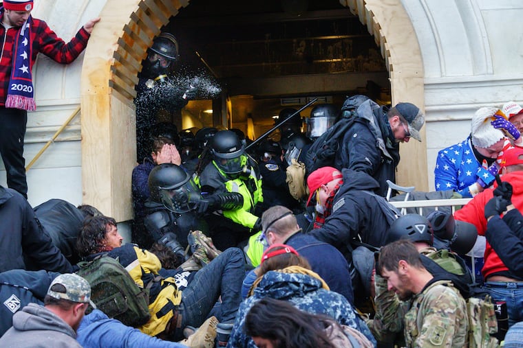 Trump Supporters and police battle at the doorway of the Capital Building, at 4:19pm, in Washington, Wednesday, Jan. 6, 2021.