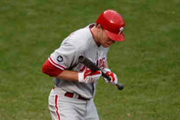 Roy Halladay's bunt was ruled fair, though Halladay was thrown out when he didn't run right away, thinking the ball was foul. Still, he got the desired result: The two runners advanced.