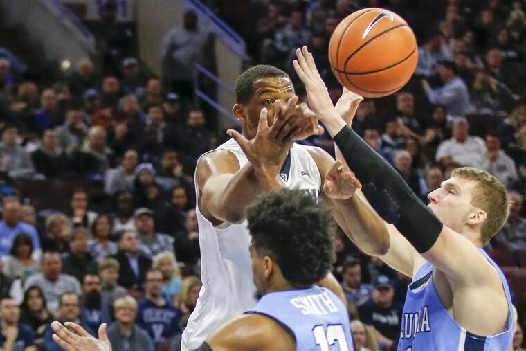 Villanova forward Omari Spellman passes the basketball past Columbia forward Lukas Meisner (right) and guard Mike Smith during the second-half on Friday, November 10, 2017 in Philadelphia.