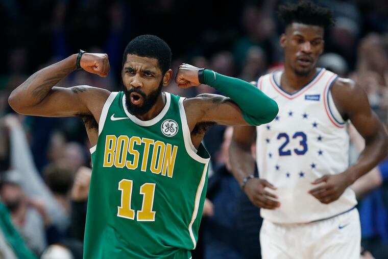 Boston Celtics guard Kyrie Irving (11) reacts in front of Philadelphia 76ers guard Jimmy Butler after making a 3-pointer in overtime.