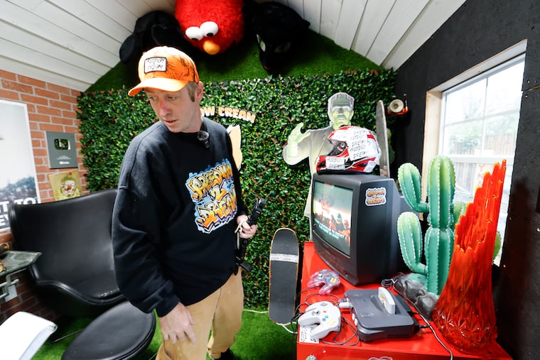 Tucker Upper stands next to some of the items he has collected by trash picking at his home in Somers Point, N.J.