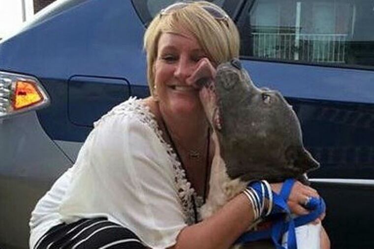 Kristin Burns hugs Max, her adopted pet.