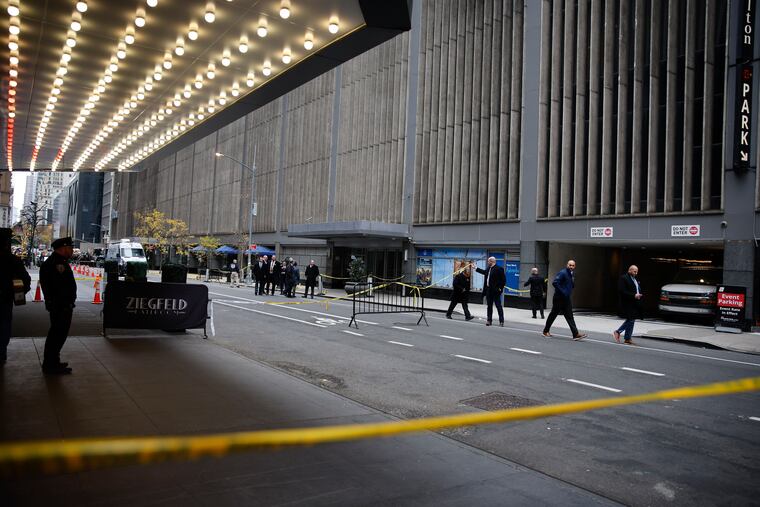 New York police investigators walk along 54th Street outside the Hilton Hotel in midtown Manhattan where Brian Thompson, the CEO of UnitedHealthcare, was fatally shot, Wednesday, Dec. 4, 2024, in New York. (AP Photo/Stefan Jeremiah)