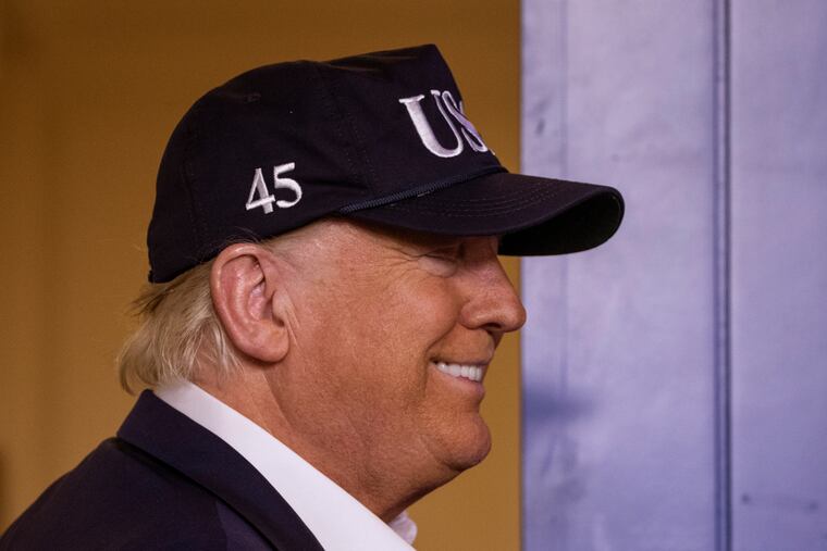 President Donald Trump talks about getting his temperature taken as he departs after speaking during a news conference about the coronavirus in the James Brady Briefing Room at the White House, Saturday, March 14, 2020, in Washington.