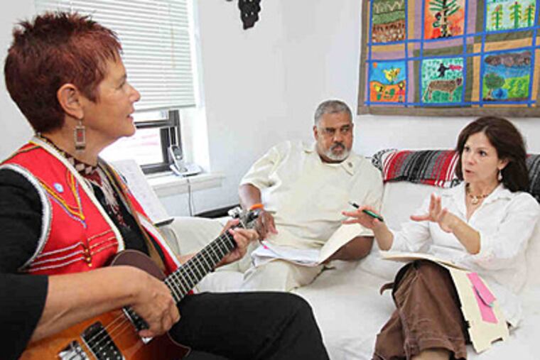 Peace Day Philly 2011 coordinator Lisa Parker (right) meets with two event volunteers, Charlie Lumpkin and Sharon Katz. (Charles Fox / Staff Photographer)