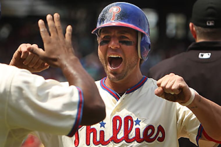 Kevin Frandsen celebrates with Juan Pierre after both scored in the first inning. (Ron Cortes/Staff Photographer)