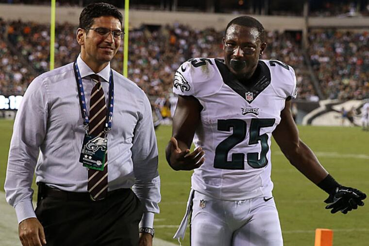 LeSean McCoy (right) walks off to have his hand examined with Dr. Matt Pepe. (David Maialetti/Staff Photographer)