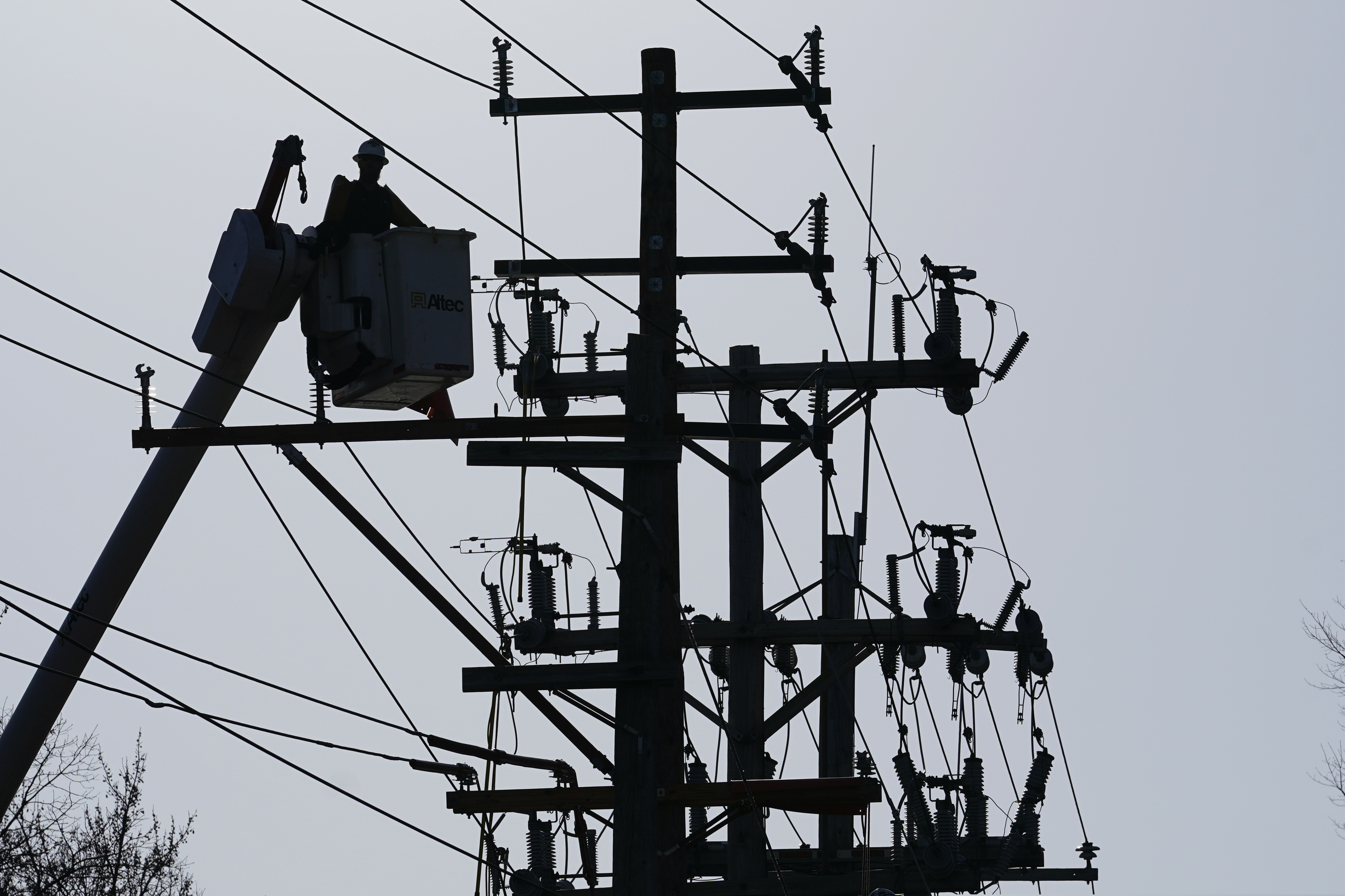 A worker works on the power lines in Annapolis, Md., on Dec. 15, 2021. Extremist groups in the United States appear to increasingly view attacking the power grid as a means of disrupting the country, according to a government report aimed at law enforcement agencies and utility operators.