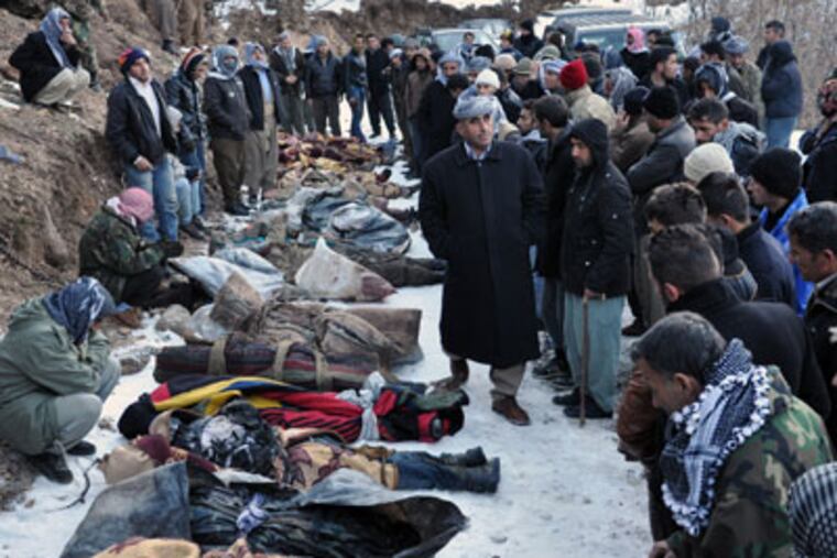People look at bodies lying on the ground after Turkey's air force attacked suspected Kurdish rebel targets across the border in Iraq, killing at least 35 people, many of them believed to be smugglers mistaken for guerrillas, near the Turkish village of Ortasu in Sirnak, Turkey, Thursday, Dec. 29. 2011. The Turkish military confirmed the Wednesday night raids, but said its jets struck an area of northern Iraq that is frequently used by Kurdish rebels to enter Turkey, after drones detected a group approaching Turkey's border. (AP Photo)