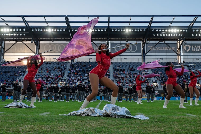 The Howard University color guard performs at halftime with the Howard University band in background during the Howard-Harvard University football game at Audi Field in Washington, D.C., in 2022.