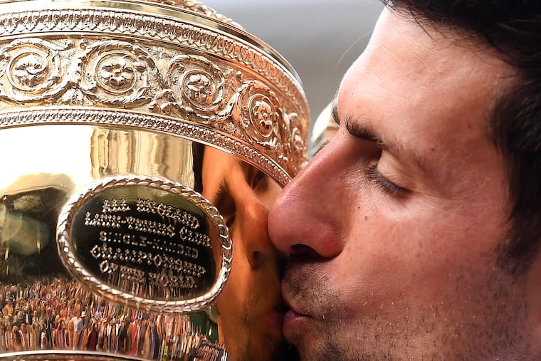 Serbia's Novak Djokovic kissing the trophy during the presentation after he defeated Switzerland's Roger Federer in the men's singles final at Wimbledon last year.