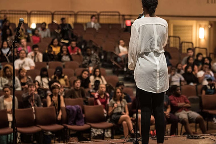Cabria Trawick, a student at KIPP, performs a poem at the Philadelphia Youth Poetry Movement Slam League semifinal Friday at the University of the Arts. (MATTHEW HALL / For The Inquirer)