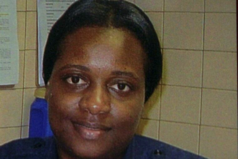 Fallen firefighter Joyce Craig-Lewis shown in a 2014 photograph hanging on her locker at Engine Company 64.