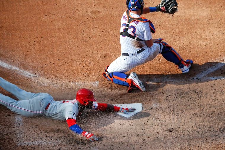 The Phillies' Odubel Herrera beats the throw to Mets catcher James McCann for a run during the sixth inning on Saturday, June 26, 2021, in New York.