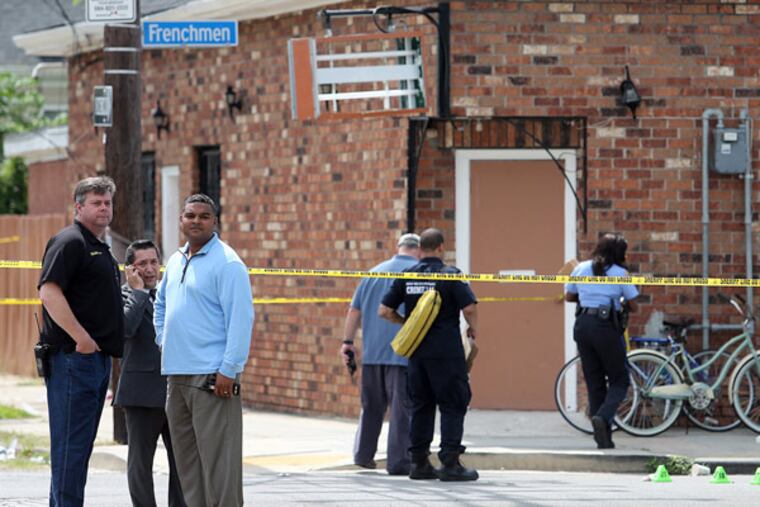 Superintendent Ronal Serpas, left, supervises as New Orleans police officers investigate the scene at the intersection of Frenchmen and N. Villere Streets after authorities say gunfire injured at least a dozen people, including a child, at a Mother's Day second-line parade in New Orleans on Sunday, May 12, 2013. (AP Photo/The Times-Picayune, Michael DeMocker)