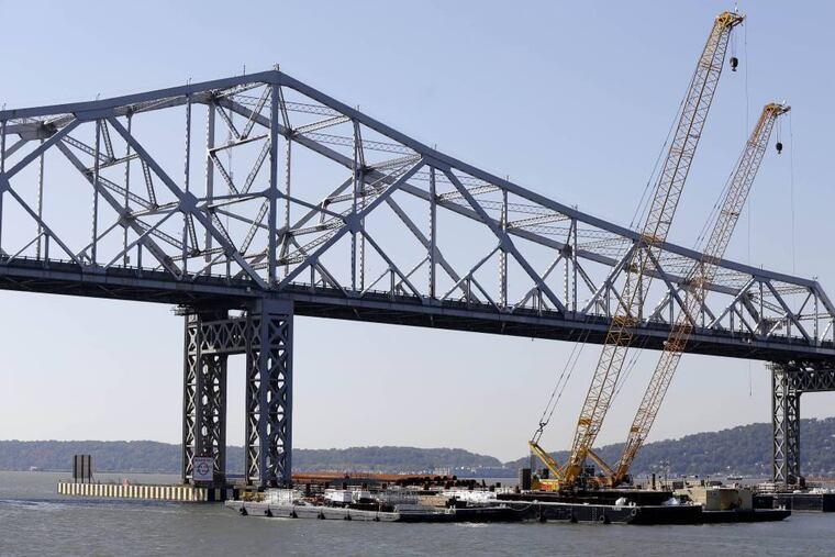 Cranes surround the construction site at the Tappan Zee Bridge that spans the Hudson River near Nyack, N.Y., Monday, Oct. 6, 2014. A large crane called the Left Coast Lifter that arrives Monday will assist in the ongoing construction at the bridge. (AP Photo/Seth Wenig)