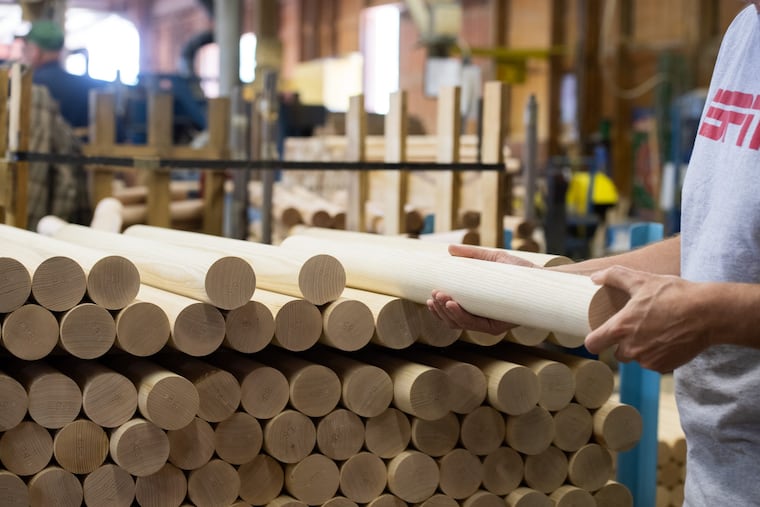 AKELEY, PA: Brian Boltz, mill general manager, inspects a finished ash billet at Larimer & Norton Mill in Akeley, PA. Mills that long supplied the bat-makers will either disappear or convert to woods like maple and birch.