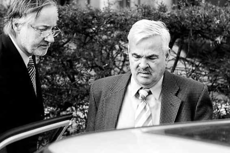 Main Line dentist Thomas William McFarland leaves the Cape May County Courthouse after pleading not guilty at his arraignment on charges of dumping medical waste that polluted beaches at the Jersey Shore last summer. A pretrial hearing is set for March 19.