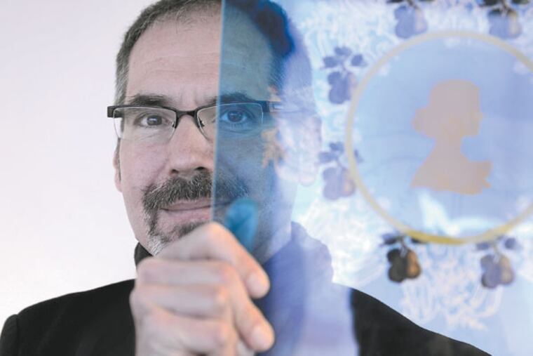 Glass artist and designer J. Kenneth Leap (cq) displays a sample of the prominent element adorning the front façade of the future Pennsauken New Jersey Transit/River Line Station. He calls the silhouette, "the enigmatic 'Jersey Girl,'" holding it while visiting his work at the Lindenwold NJ Transit station. ( TOM GRALISH / Staff Photographer )