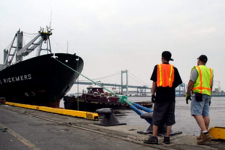 William Thompson (left) and Bob Ragonese pause while securing ropes as a ship docks at the Packer Terminal.