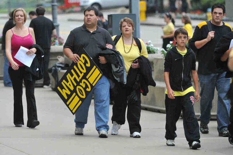 Extras taking part in the filming of a fictional football game for the forthcoming Batman film "The Dark Knight Rises" head into Heinz Field in Pittsburgh.