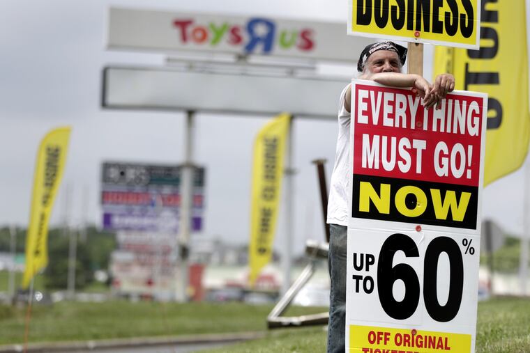 A man holds up a sign announcing the going out of business sale at a Toys R Us and Babies R Us store location, Friday, June 1, 2018, in Totowa, N.J. Politicians, including U.S. Sen. Bob Menendez and Sen. Cory Booker, held a news conference at the Totowa location to voice their concerns after it was announced that employees will not get severance packages once the stores are closed following the bankruptcy of the company.