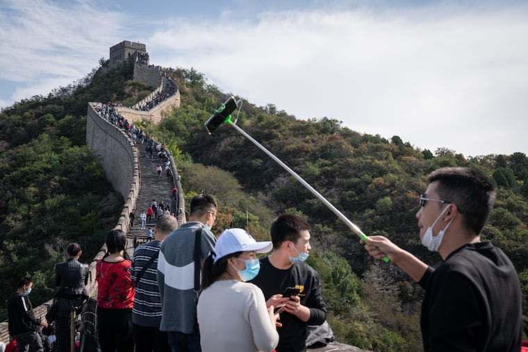 A visitor poses for a selfie photograph at the Badaling section of the Great Wall in Beijing. People will be doing these things again soon, the Expedia CEO predicts.