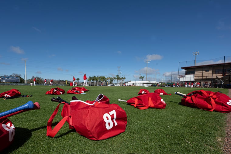 Equipment bags are scattered on the field at BayCare Ballpark as the Phillies have their first full-squad workout of spring training in Clearwater, Fla.
