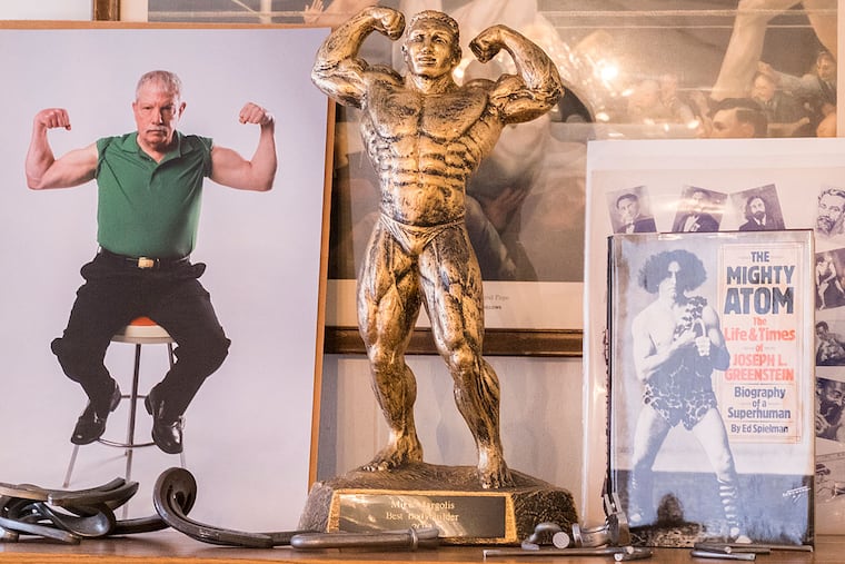 Manayunk's strongman Mike Margolis, 74, can still bend 60D galvanized spikes with his bare hands. Here, old photos and memoribilia in Mike’s office.