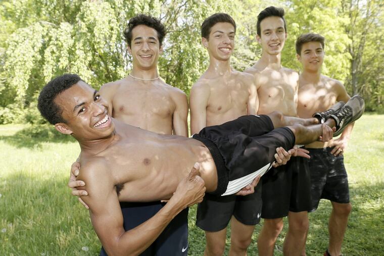 Cinnaminson runner Justin Arnold is supported by teammates Austin Gabay, Zack Walton, Tommy Ungvarsky and Max Adams during practice.