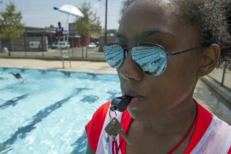 At the Athletic Rec Center pool (1400 N. 26th St.), first-year lifeguard Khadijah Davis, 17, a senior at CAPA, watches a swimmer in the pool.