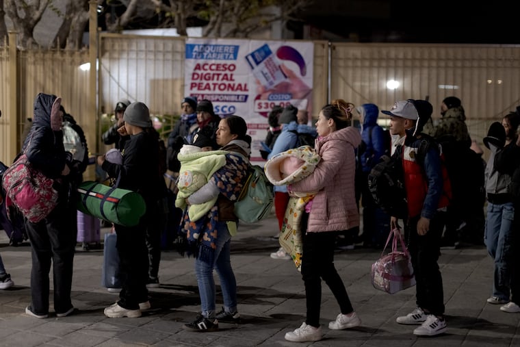 People seeking asylum in the United States wait in line for their appointment at the entrance to the Paso del Norte International border bridge in Ciudad Juárez, Mexico, on Jan. 20, 2025.