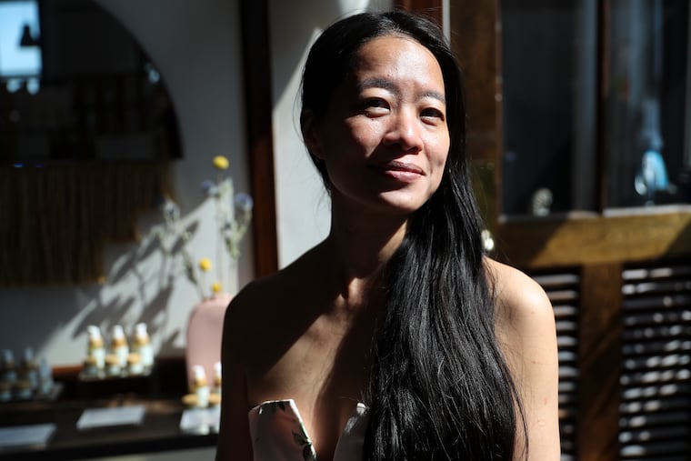 Adeline Koh poses for a portrait inside her shop, Sabbatical Beauty, on the third floor of the Bok Building in Philadelphia on Thursday, April 20, 2023.