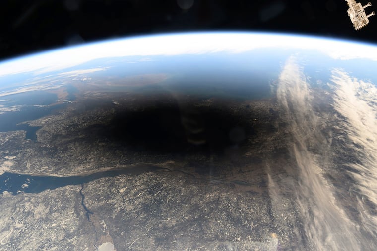 This photo provided by NASA shows the Moon's shadow covering portions of Canada and the U.S. during a total solar eclipse as seen from the International Space Station on Monday, Aug. 8, 2024. Two total eclipses will occur in 2026.