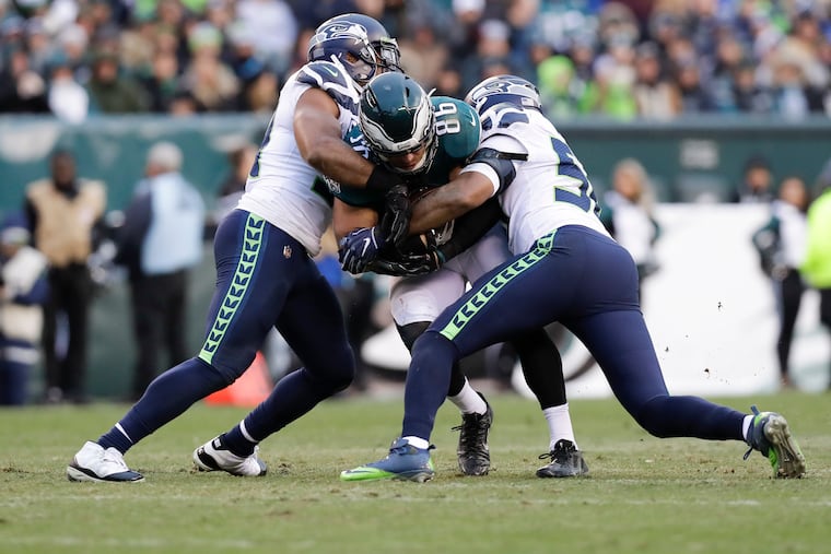 Seahawks linebackers Bobby Wagner (left) and K.J. Wright (right) take down Eagles tight end Zach Ertz in November.