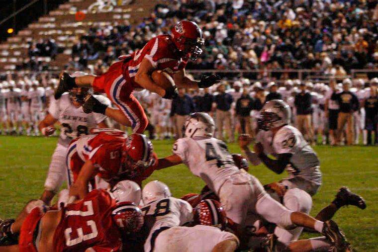 Neshaminy's Anthony Woodroffe takes the high road, vaulting over the pile for a touchdown in a 28-21 win over Council Rock South on Oct. 15. Neshaminy takes on visiting Upper Dublin, while Council Rock South hosts Souderton in Friday's District 1 Class AAAA playoff openers.