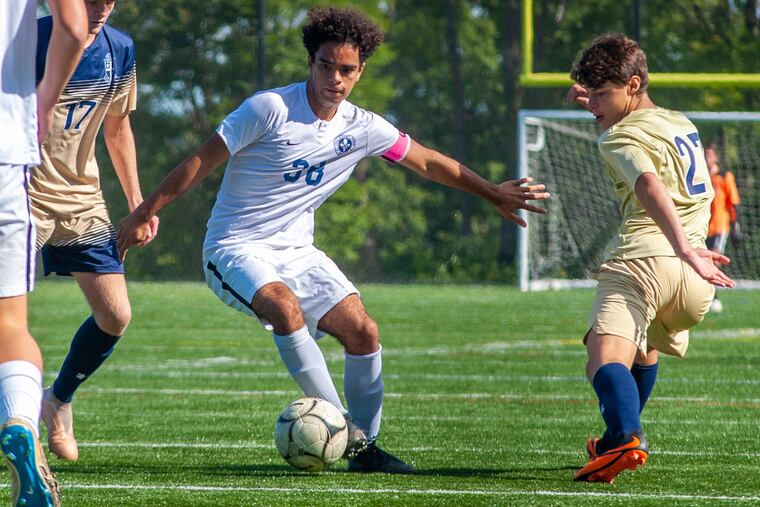 Holy Ghost Prep's Tony Colon controls the ball as La Salle’s James Barton (17) and Tim Madden (27) defend in the second half of the boys' soccer game Sunday.