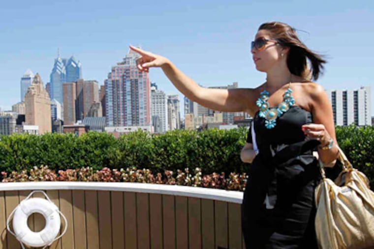Allison McClellan on the rooftop of the South Broad Street building, with its view of the city skyline, where she planned to be renting with her boyfriend, Mike Lang. (Charles Fox / Staff Photographer)