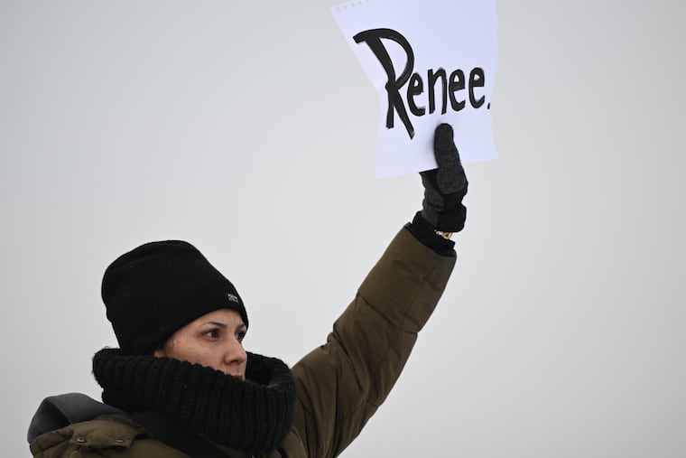A protesters holds up a sign reading "Renee", the woman shot and killed by a U.S. Immigration and Customs Enforcement officer in Minneapolis on Wednesday.
