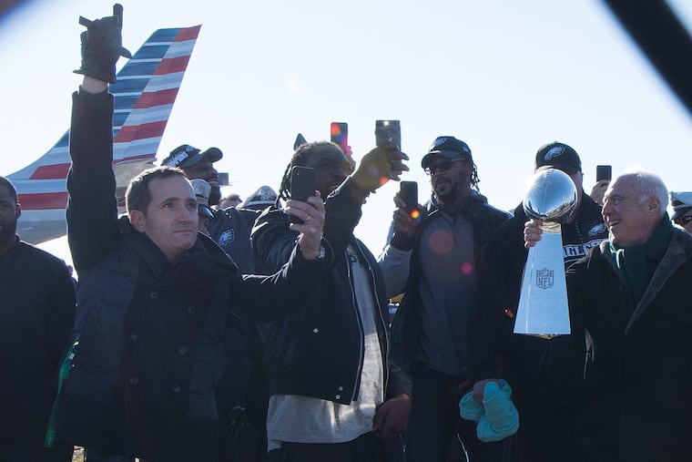 Howie Roseman (left), here with Jeffrey Lurie (right) and Eagles players after arriving back in Philly as Super Bowl champs, now must navigate the post-championship terrain.