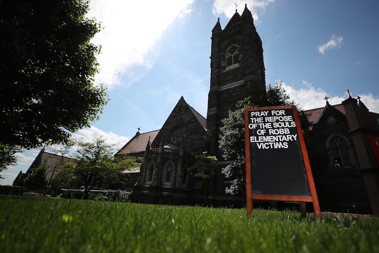A message on a sign reads ”Pray for the repose of the souls of Robb Elementary victims” outside the Church of St. Martin-in-the-Fields in Philadelphia on Sunday.