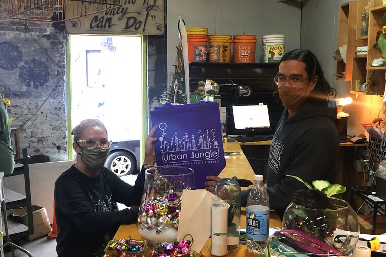 You can shop at local stores this holiday season, as long as you practice patience and social distancing. Shoppers are pictured at Urban Jungle, 1526 E Passyunk Ave.