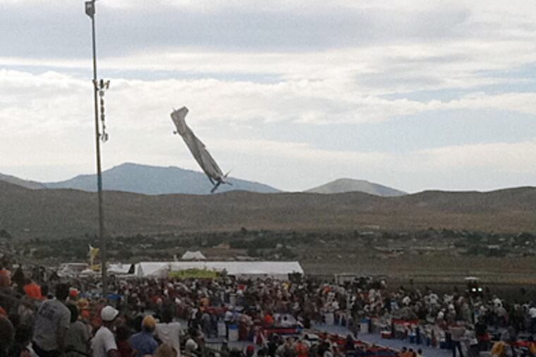 A P-51 Mustang airplane approaches the ground immediately before crashing during an air show in Reno, Nev. The vintage World War II-era fighter plane piloted by Jimmy Leeward plunged into the grandstands during the annual air show. (Garret Woodson / Associated Press)