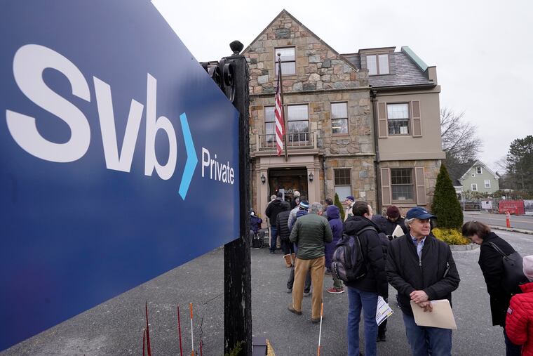 A line forms outside a Silicon Valley Bank branch location on March 13, 2023, in Wellesley, Mass.
