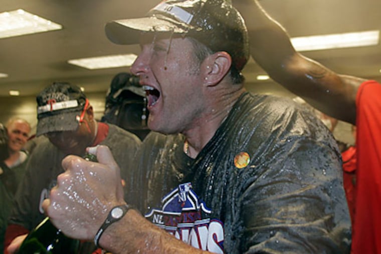 Mike Sweeney got a Champagne shower from Ryan Howard in the locker room after last night's win. (Yong Kim/Staff Photographer)