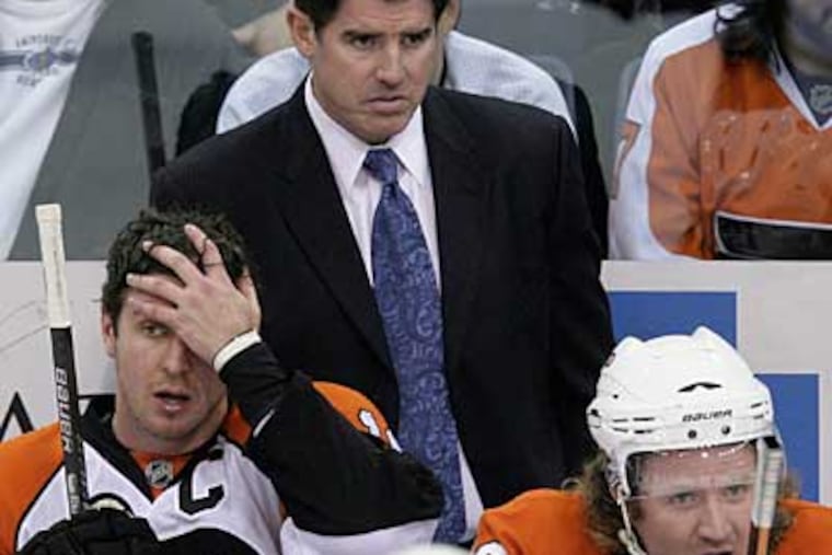 Flyers coach Peter Laviolette stands behind Mike Richards, left, and Scott Hartnell during the second period against the Penguins. (AP Photo / Gene J. Puskar)