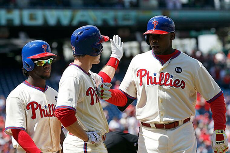 Phillies' Ryan Howard celebrates after hitting a first-inning three-run home run with teammates Chase Utley and Odubel Herrera against the Atlanta Braves on Sunday, April 26, 2015 in Philadelphia. YONG KIM / Staff Photographer